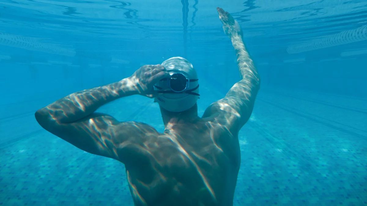SONR Music device worn on the back of the head, by a swimmer underwater