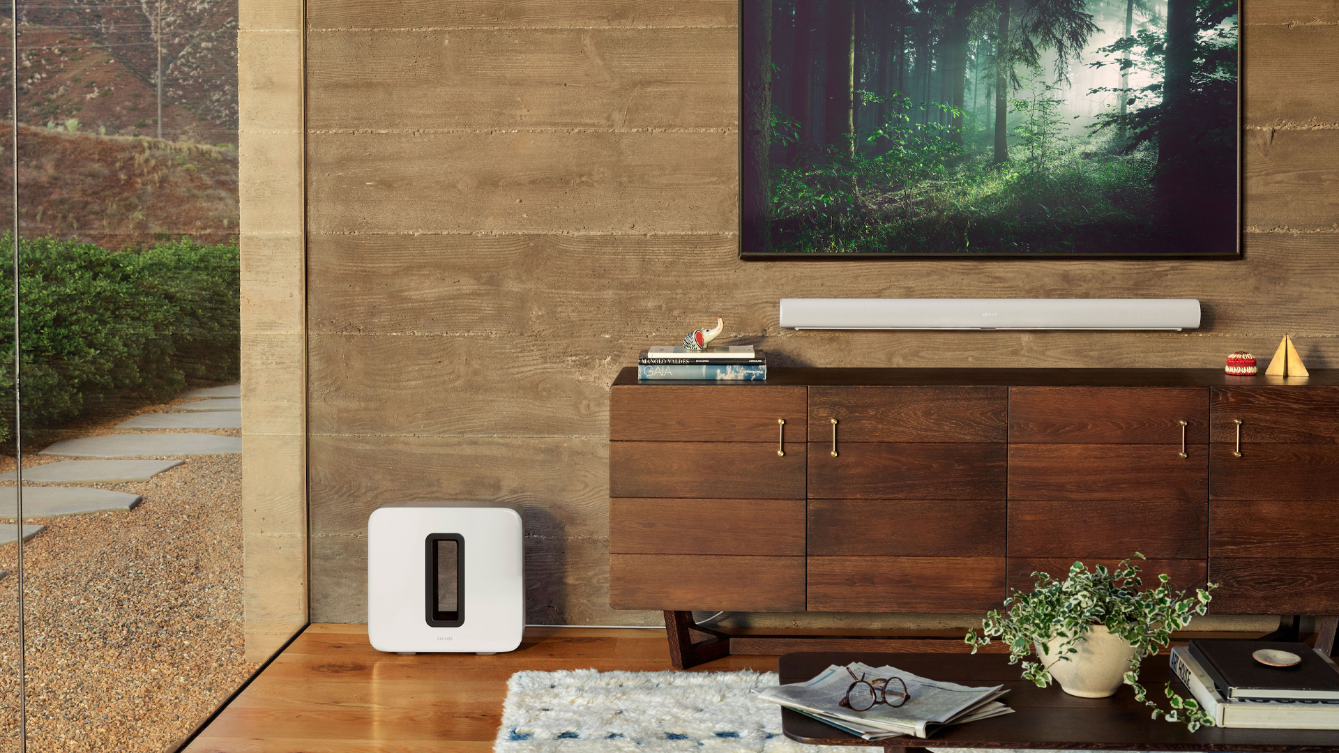The Sonos Arc white soundbar with the Sonos Sub in white in a wooden living room