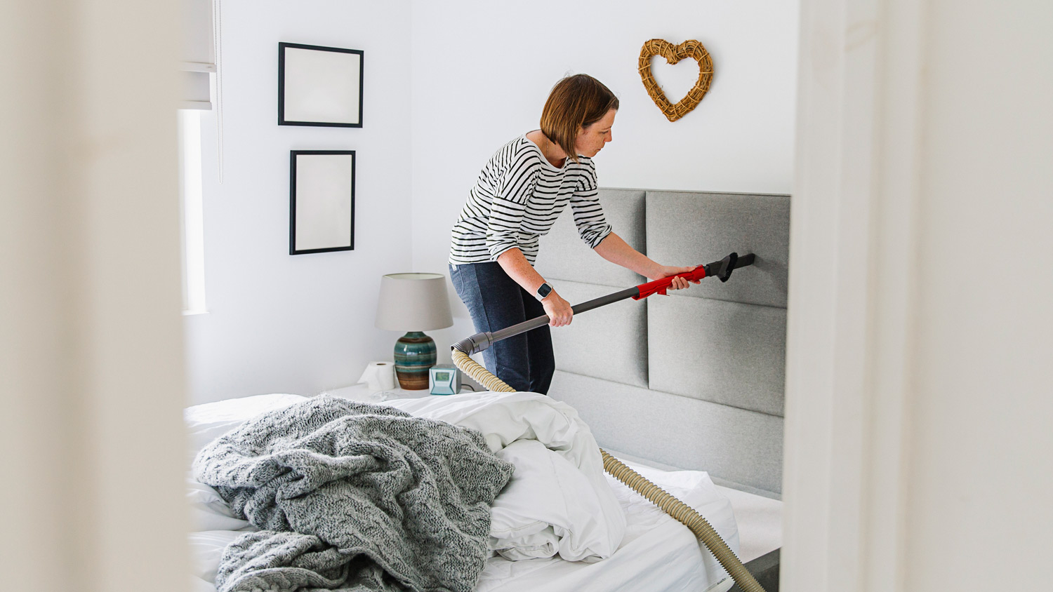 A person deep cleaning a bedroom