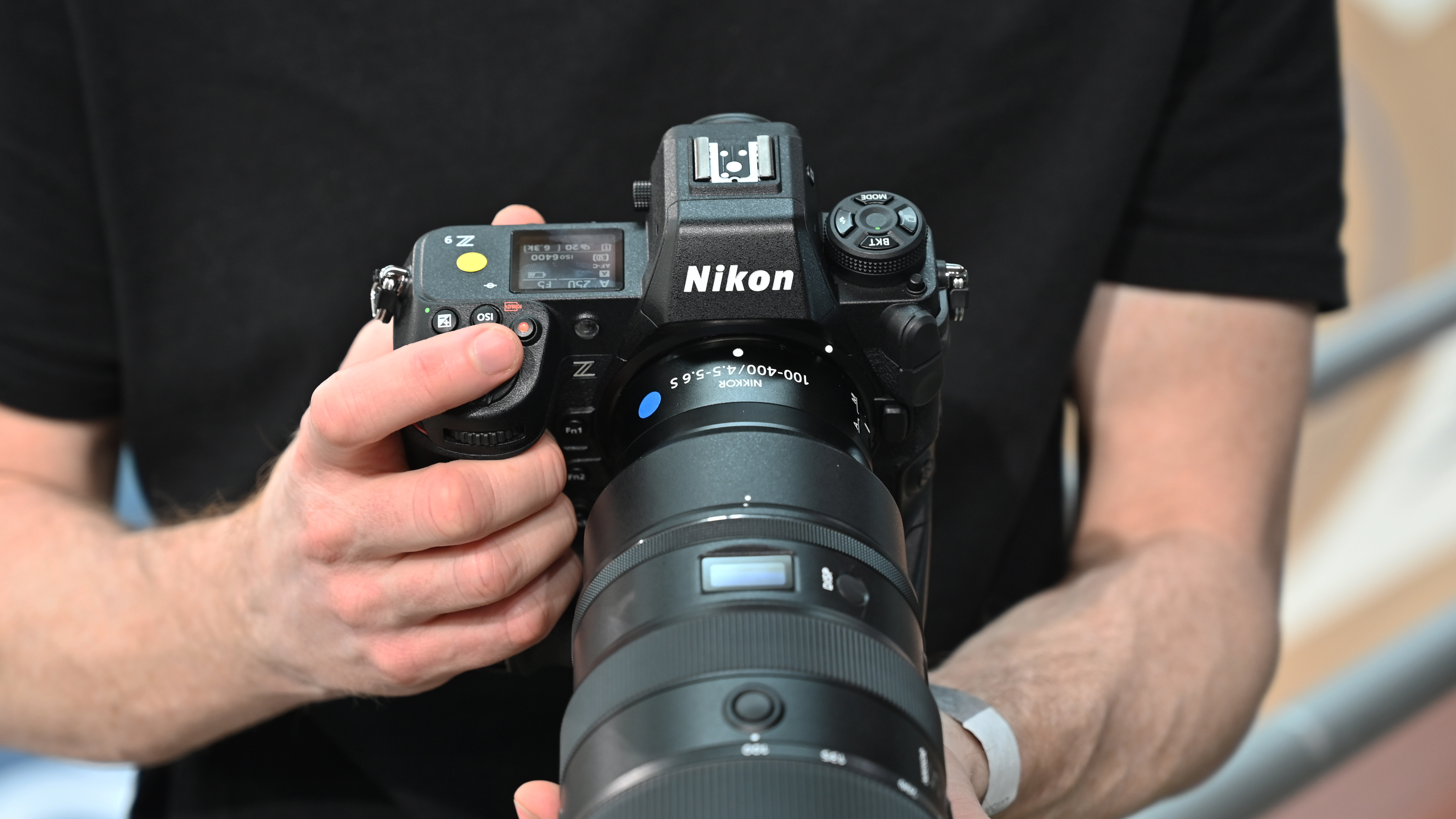Hands holding the Nikon Z9 mirrorless camera