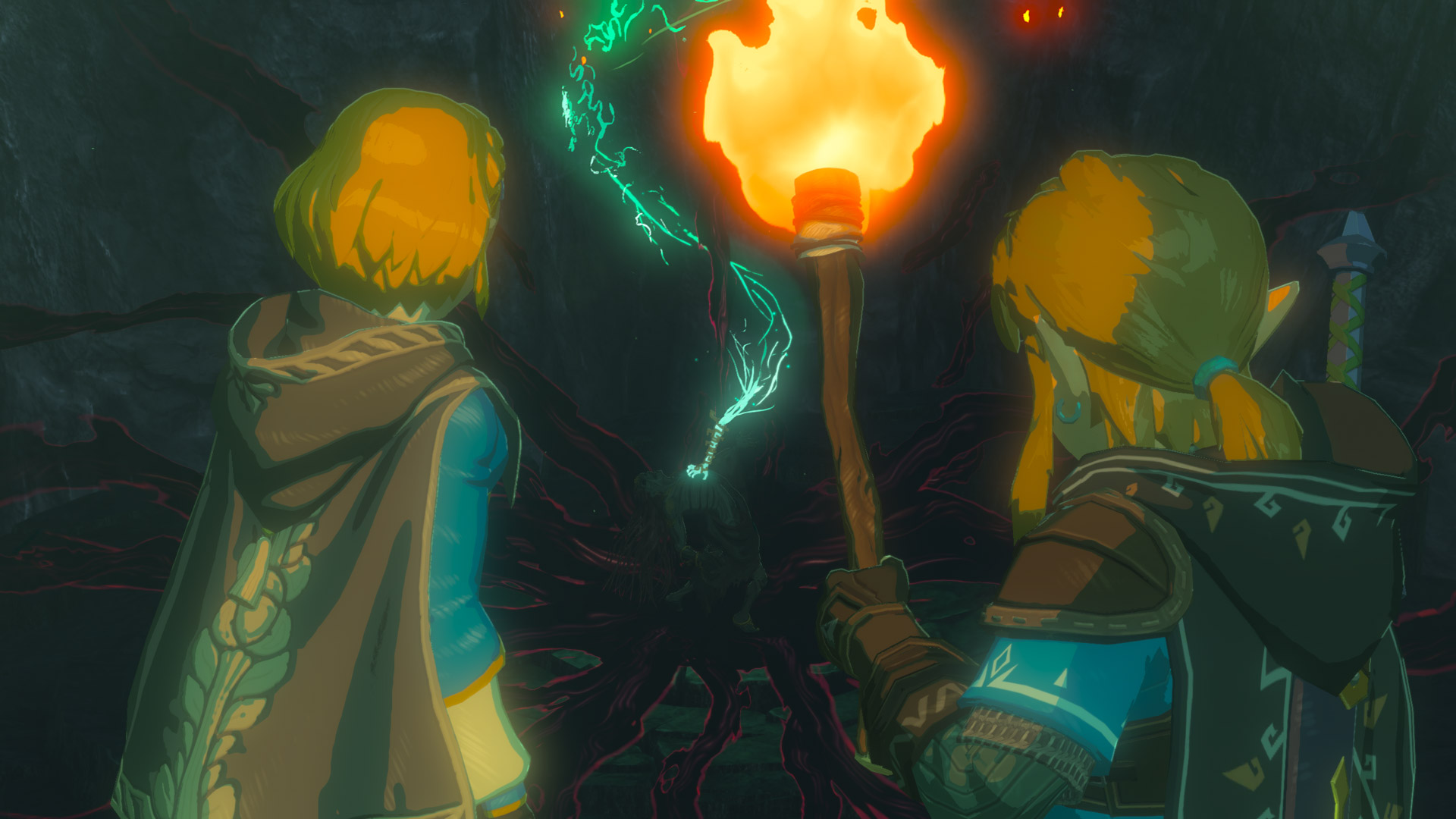 Link and Zelda holding a torch enter a dark passageway