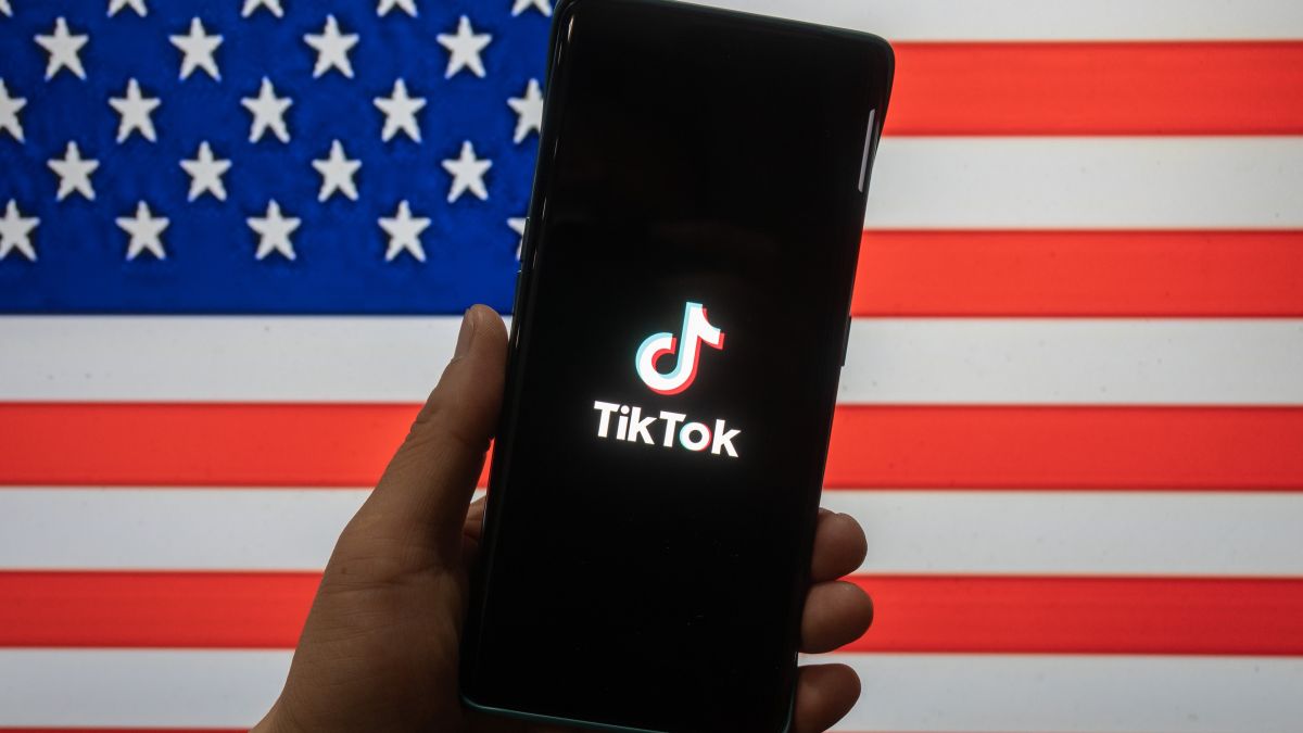 TikTok on a phone in front of the USA flag