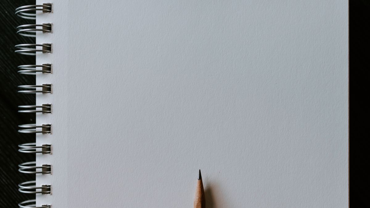 a blank piece of paper with a pencil on top