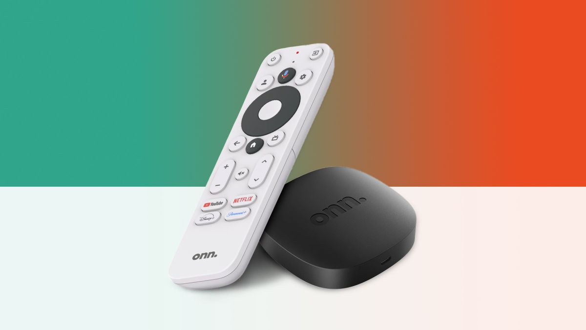 The Onn Google TV 4K Streamer and its remote sit next to each other on a white surface, with a colorful background behind them
