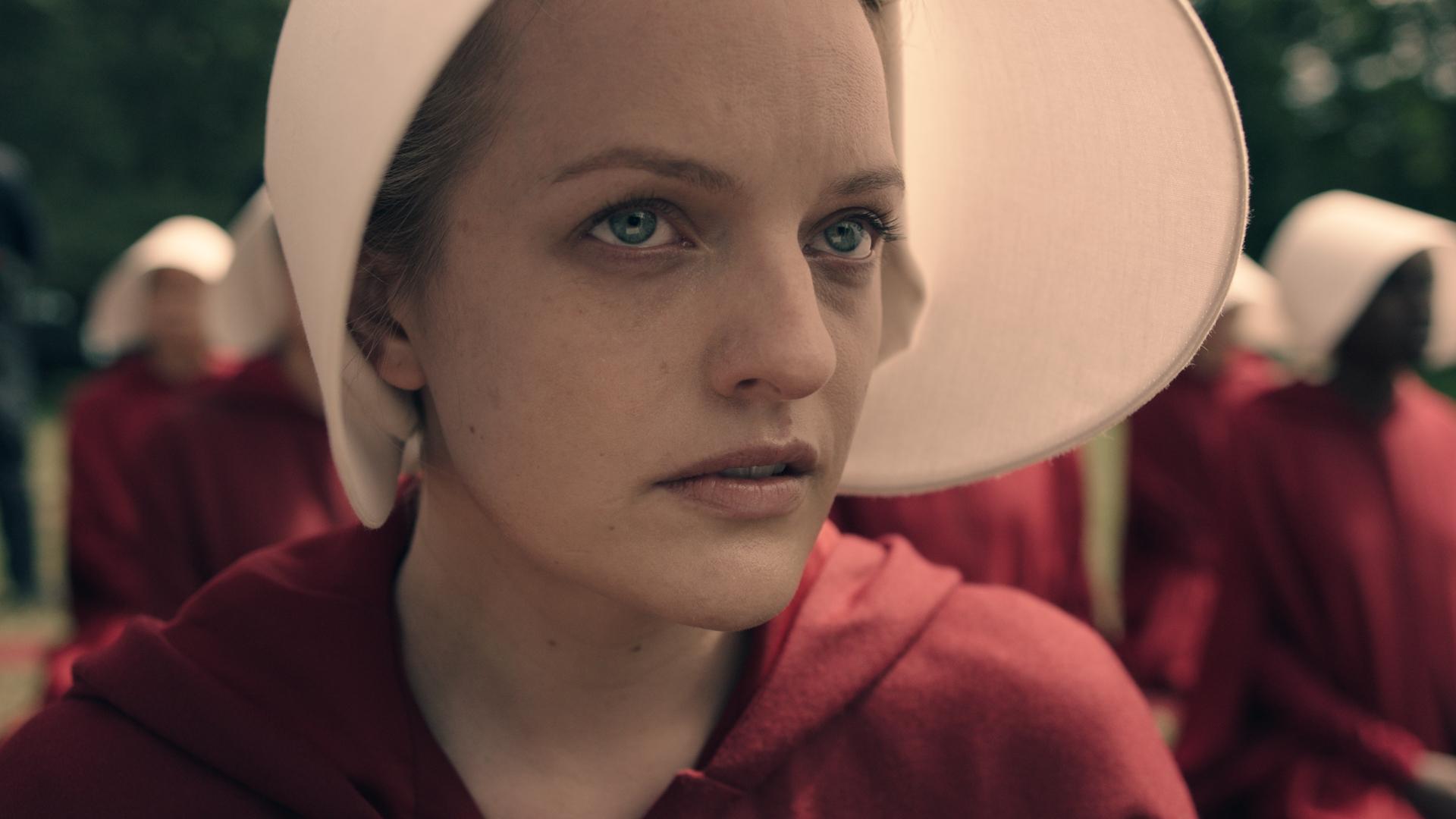Elizabeth Moss' Offred looks at something off camera in The Handmaid's Tale