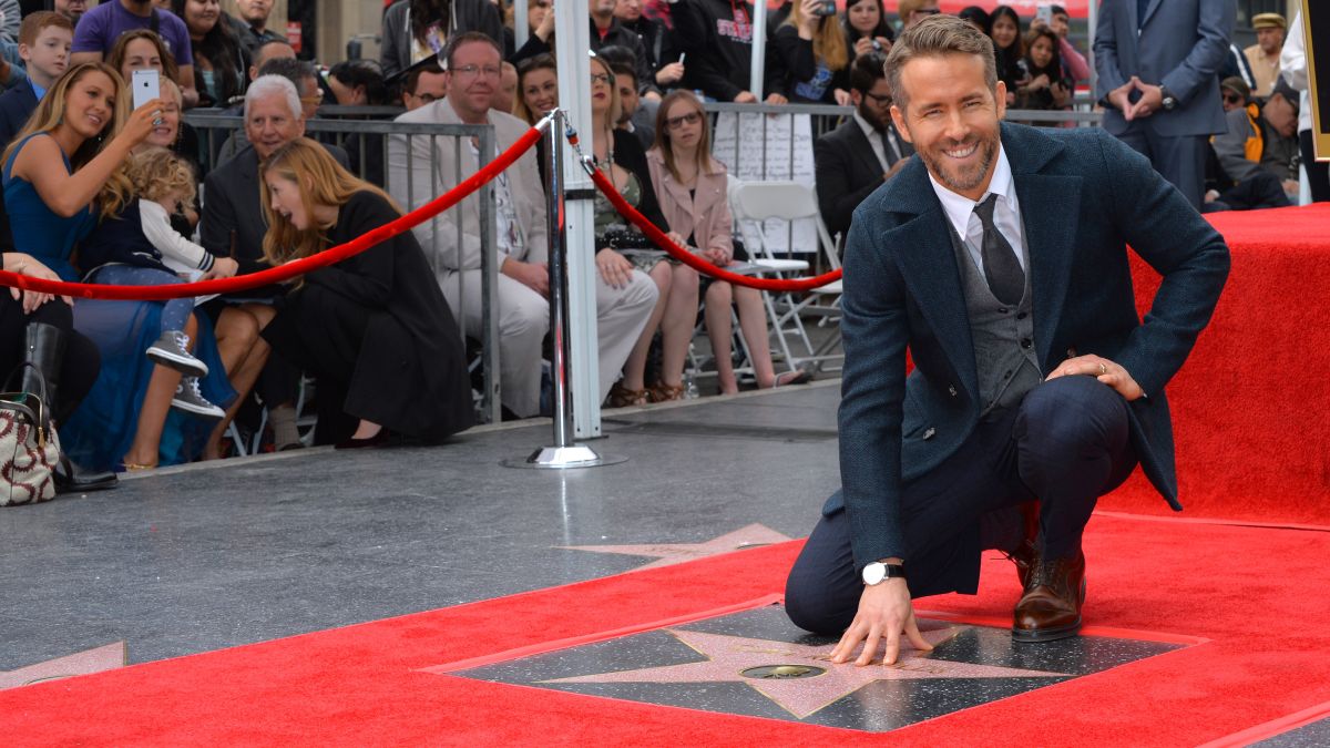 Ryan Reynolds kneeling over a star