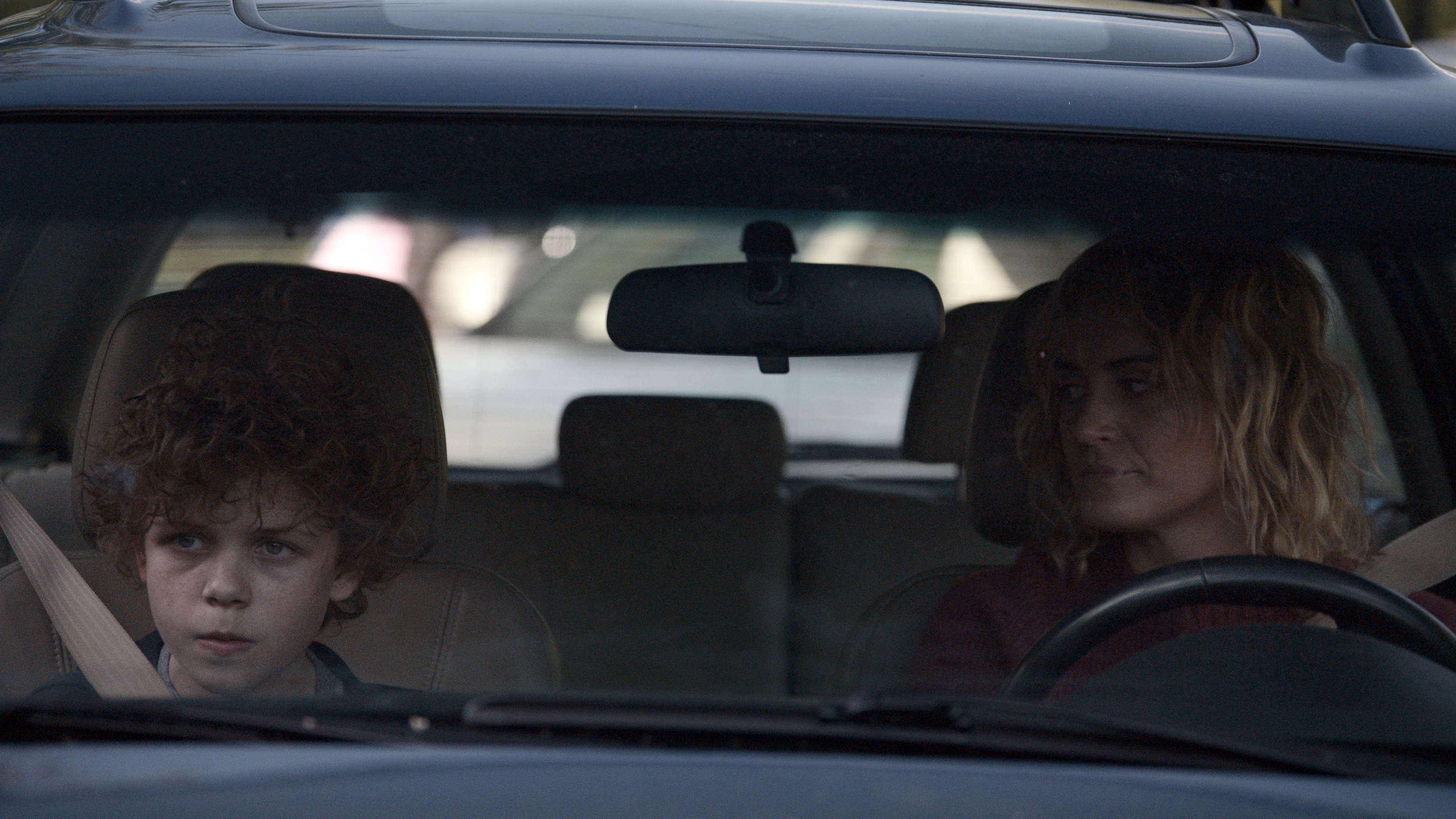 Lacey looks at Edward as they sit in a car in Dear Edward