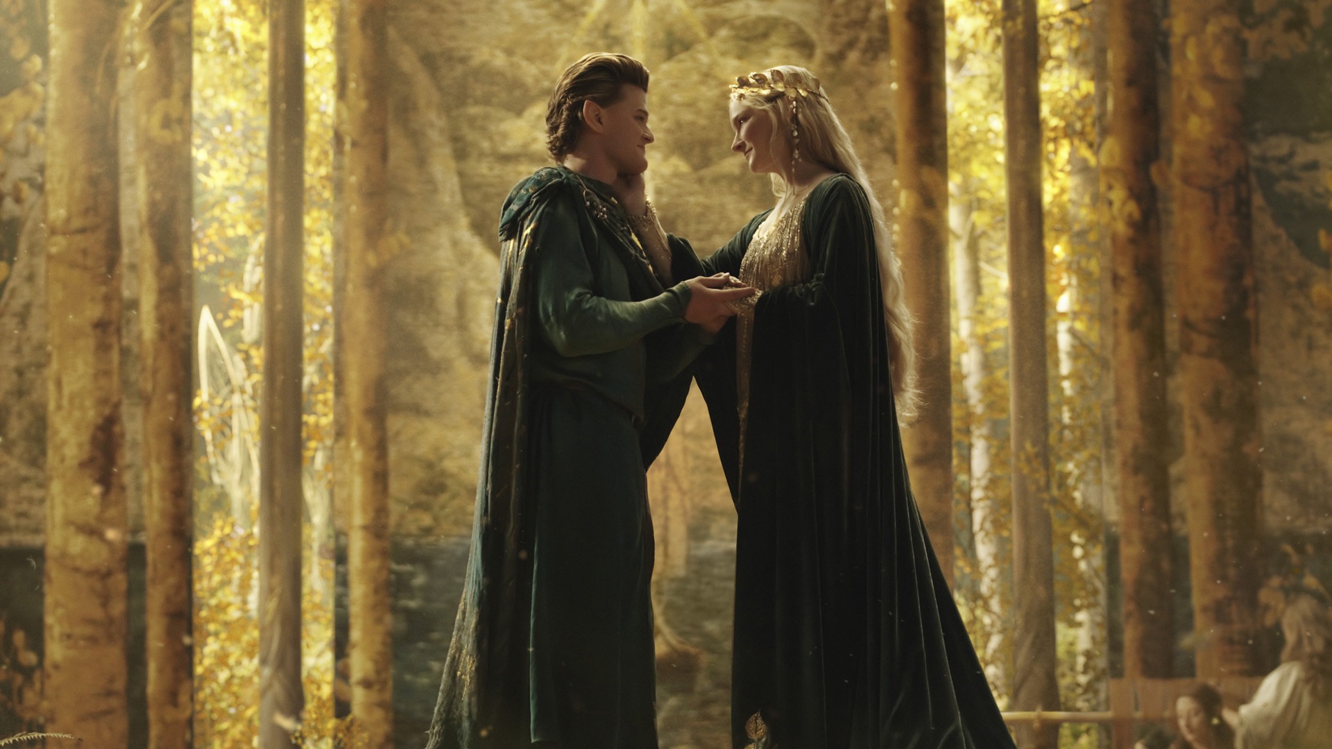 Elrond and Galadriel embrace as they reunite in Lothlorien in The Rings of Power episode 1