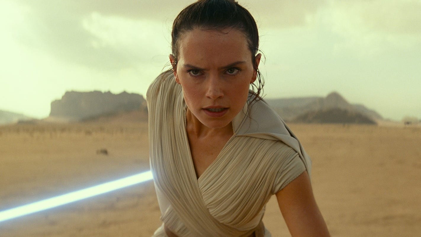 A close up of Rey wielding her lightsaber in Star Wars: The Rise of Skywalker