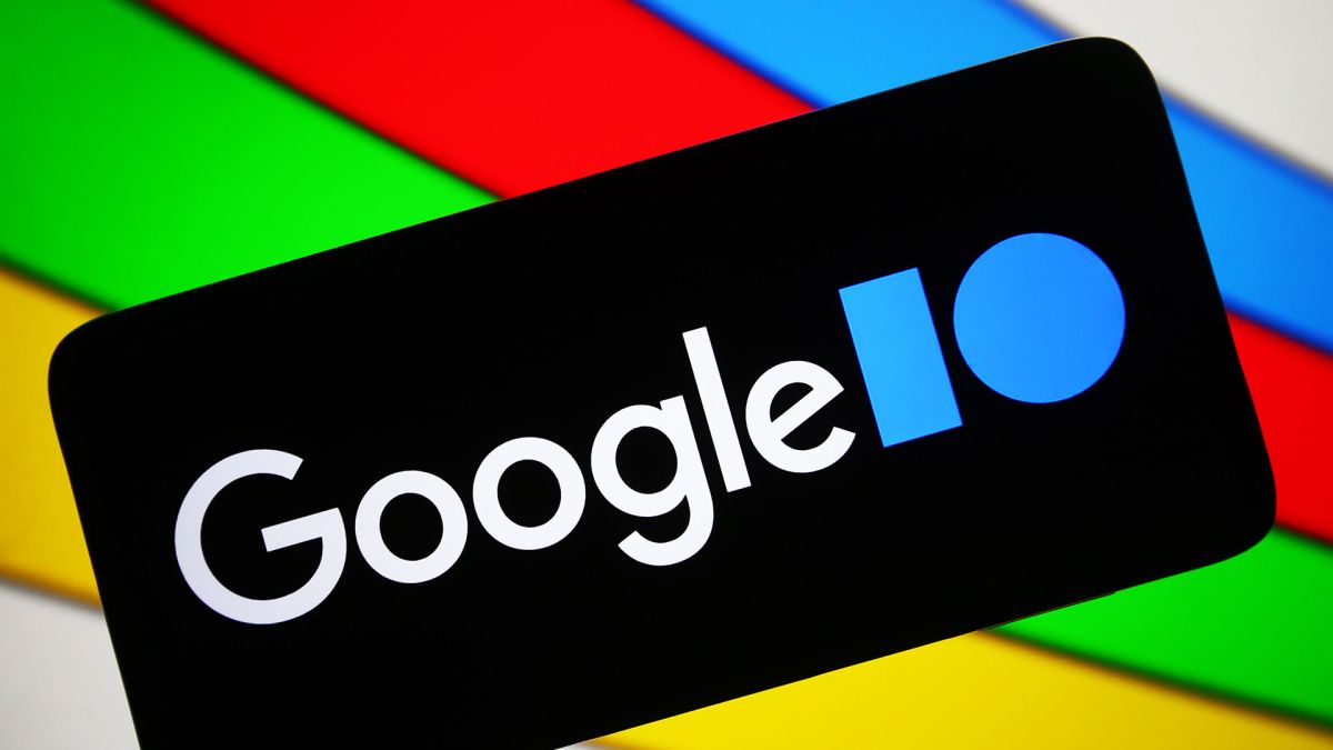 The Google I/O logo on a black smartphone against a colorful background using the Google colors