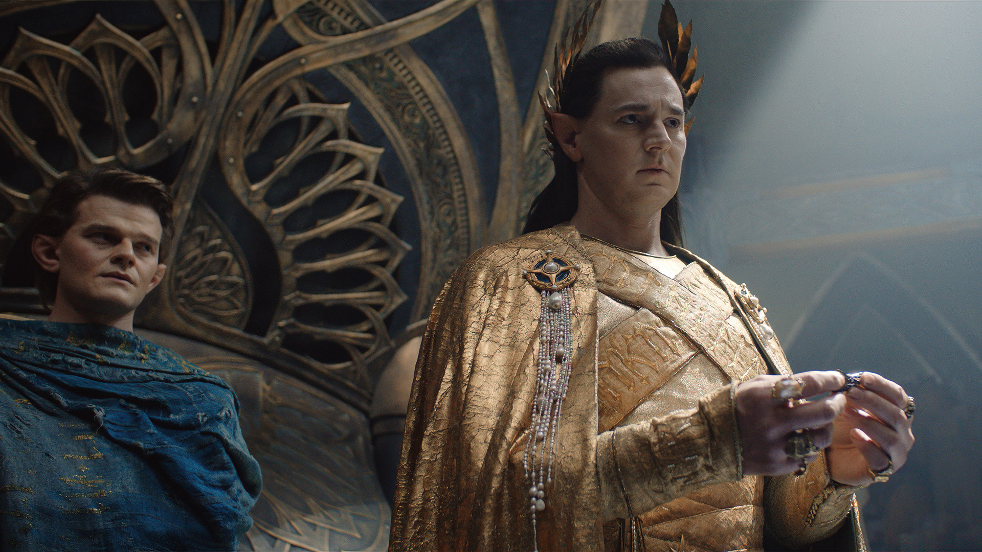 Gil-galad holds a piece of mithril as Elrond watches on in The Rings of Power episode 8