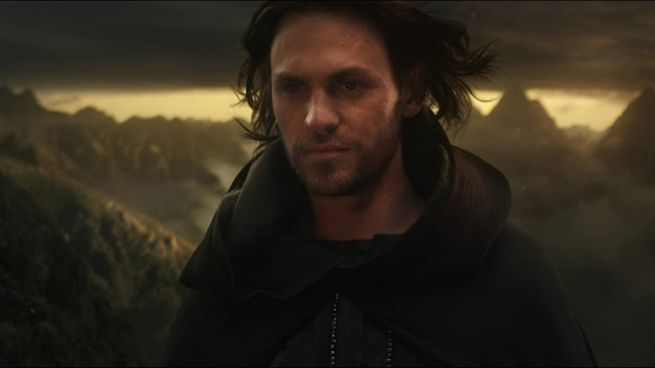 Halbrand, now known as Sauron, smirks as he looks out onto Mordor and Mount Doom in The Rings of Power episode 8
