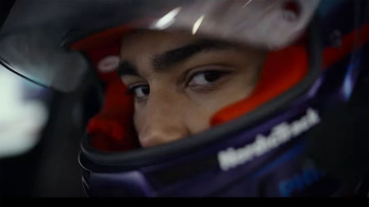 A race car driver looks directly into the camera in the Gran Turismo movie